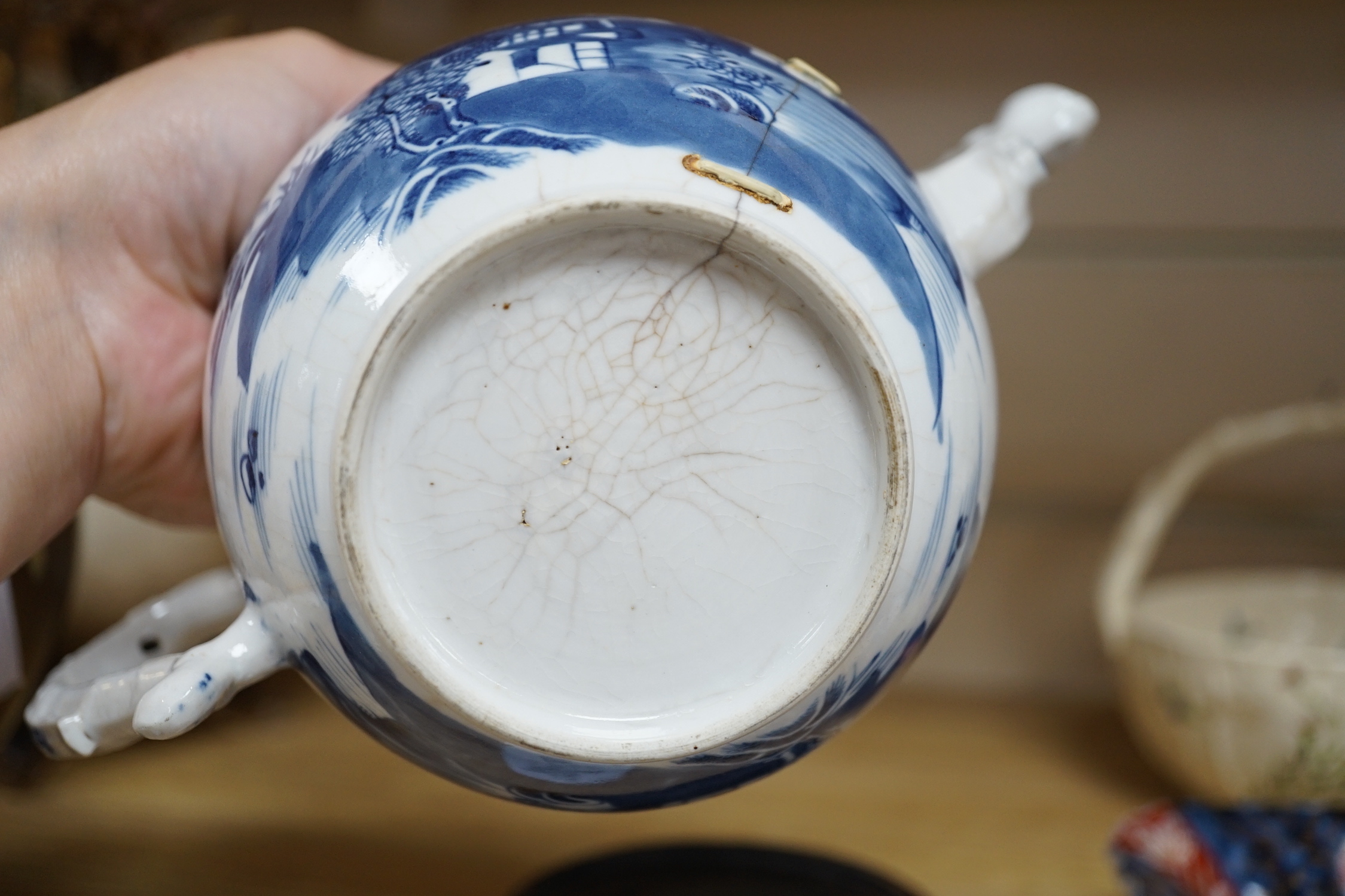 An 18th century Chinese blue and white teapot and cover, with hardwood stand, 19cm total height